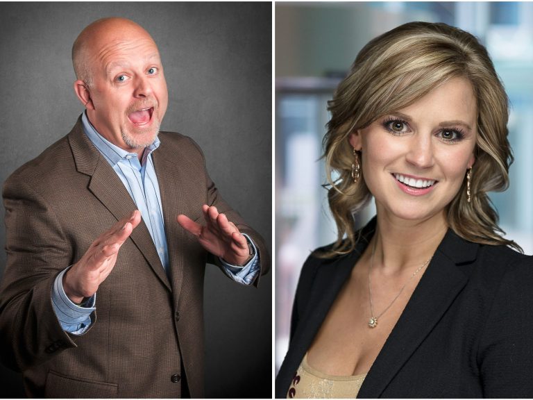 A man in a suit gestures enthusiastically next to a smiling woman in a blazer.