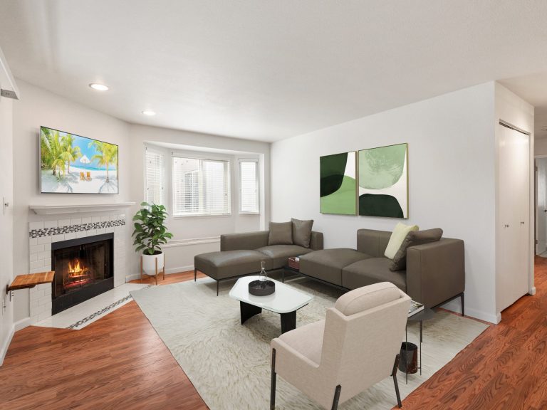 Modern living room with a sectional sofa, fireplace, and abstract wall art. Bright, inviting space.